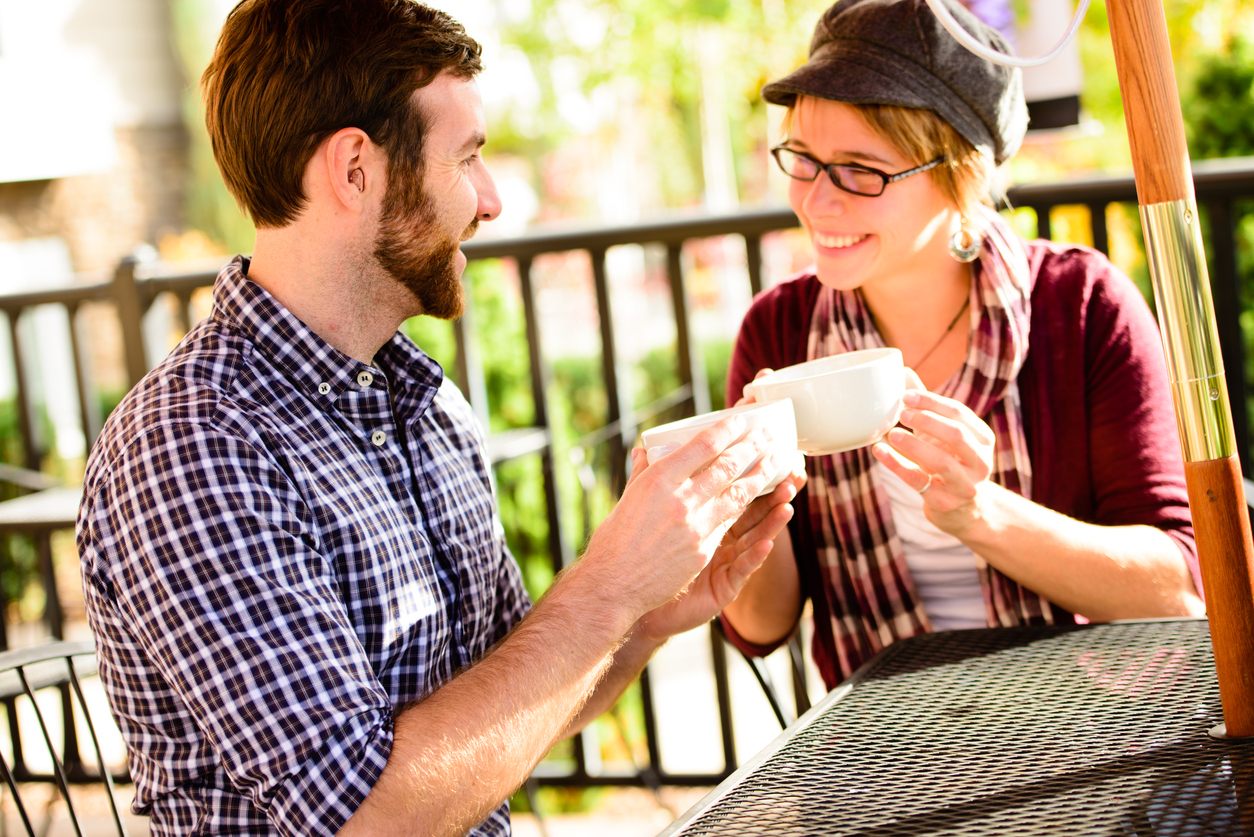 Modern hearing aid wearers at coffee shop