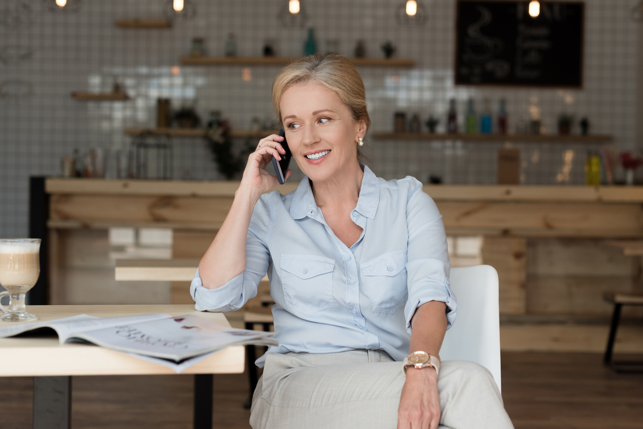 Woman talking on phone with hearing aid