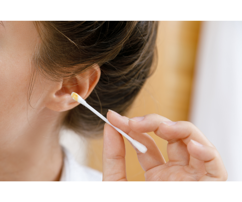 Woman holding cotton swab with earwax
